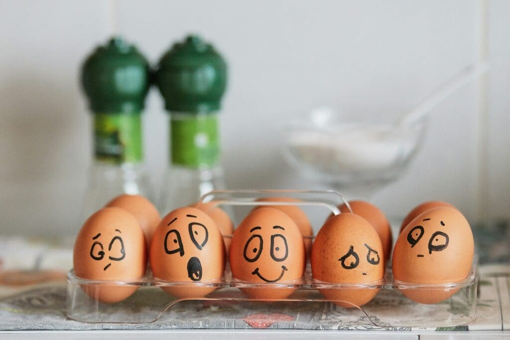 Eggs in a carton displaying different emotions.